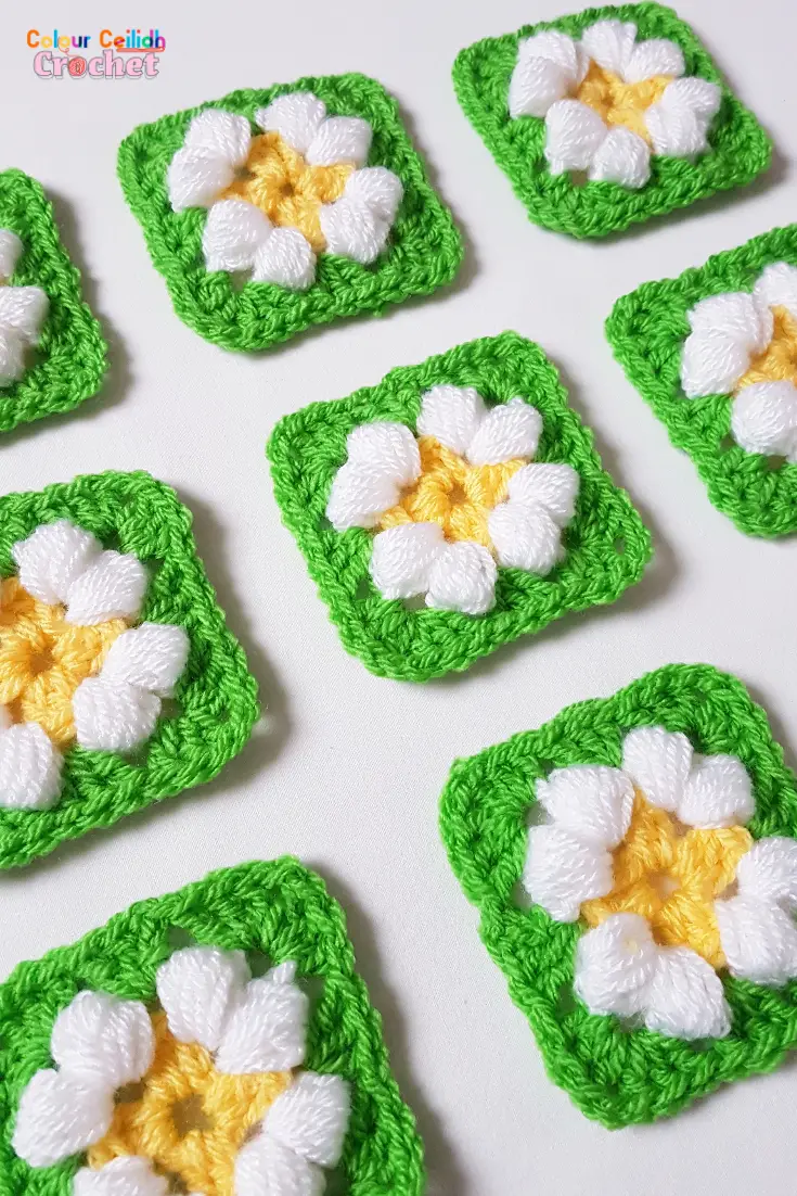 This is an easy crochet puff daisy granny square pattern for a small daisy flower in bright and cheerful colours.