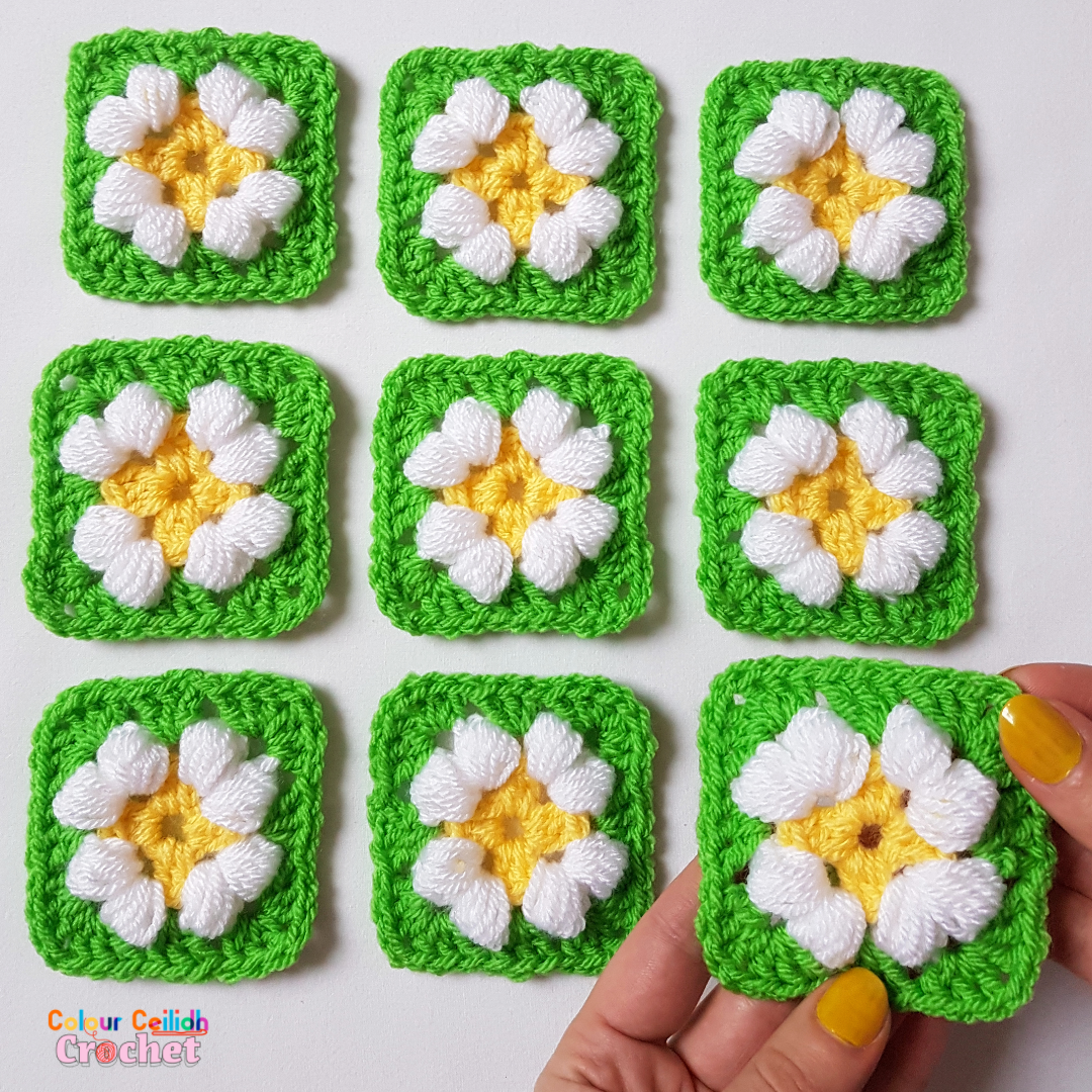 This is an easy crochet puff daisy granny square pattern for a small daisy flower in bright and cheerful colours.