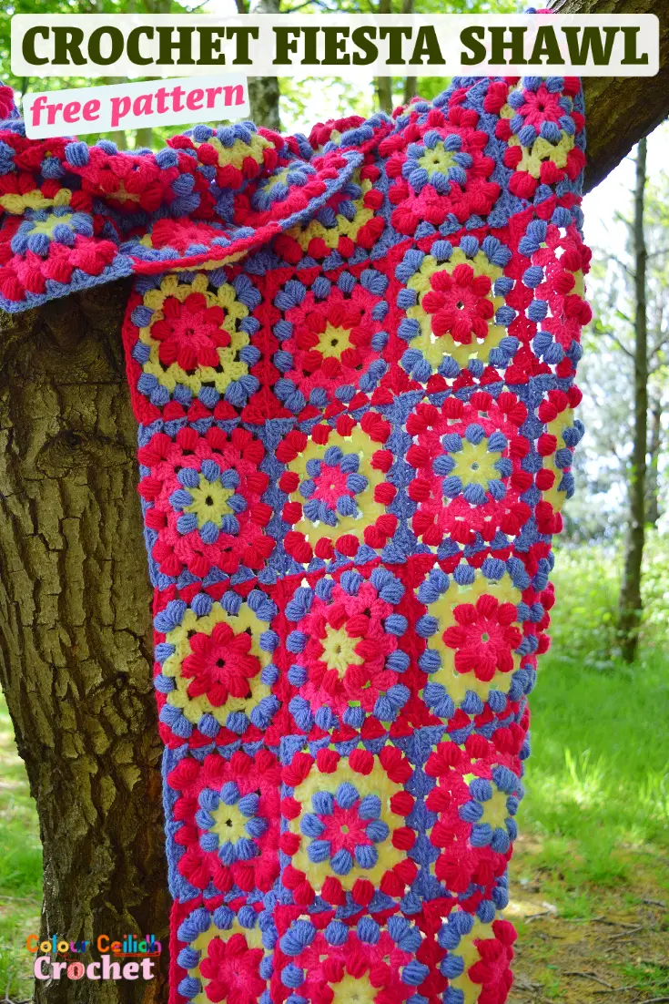 This simple and easy beginner rectangle crochet shawl only uses two stitches for texture and bold color combinations using Stylecraft Special DK yarn including Bright Pink and Fiesta to create a boho crochet shawl. Embrace your inner bohemian style chic with these puff stitch granny squares. Wear it like a warm scarf when you fold it in half or wrap it around your shoulders. Layer it over blue jeans and neutral shades. Free pattern. #crochetshawl #freecrochetpattern #stylecraftyarns