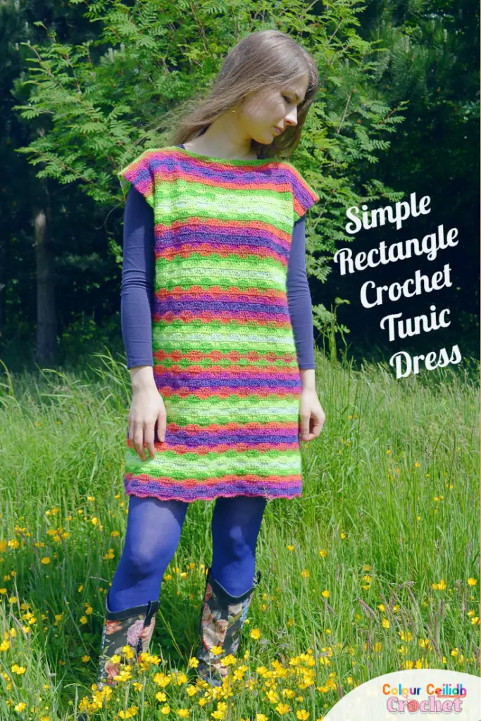 This crochet tunic dress pattern with sleeves is a simple rectangle seamed at the sides and shoulders. Click for the free pattern and diagram. This easy beginner crochet tunic dress only uses single and double crochet stitches to create a subtle wavy stitch pattern to make the usual stripes a little more interesting. I love the super simple shape which looks great as is or you could belt it too. I love how it frames my shoulders and creates loose fitting comfortable sleeves without even trying.