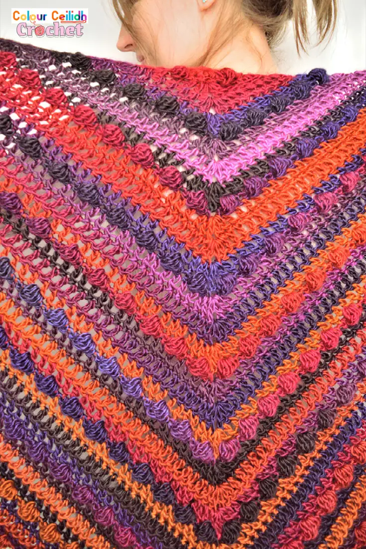 This beginner friendly and easy crochet shawl is very cosy and warm as it's made with the solid granny and bobble stitches. I use a large crochet hook which means it works up fast! And the yarn I use offers wonderful color transitions which make the time go fast because you never know what the next row is going to look like.
