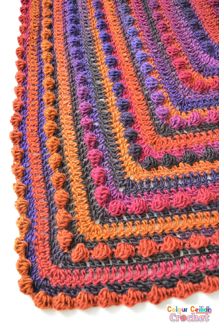 This beginner friendly and easy crochet shawl is very cosy and warm as it's made with the solid granny and bobble stitches. I use a large crochet hook which means it works up fast! And the yarn I use offers wonderful color transitions which make the time go fast because you never know what the next row is going to look like.