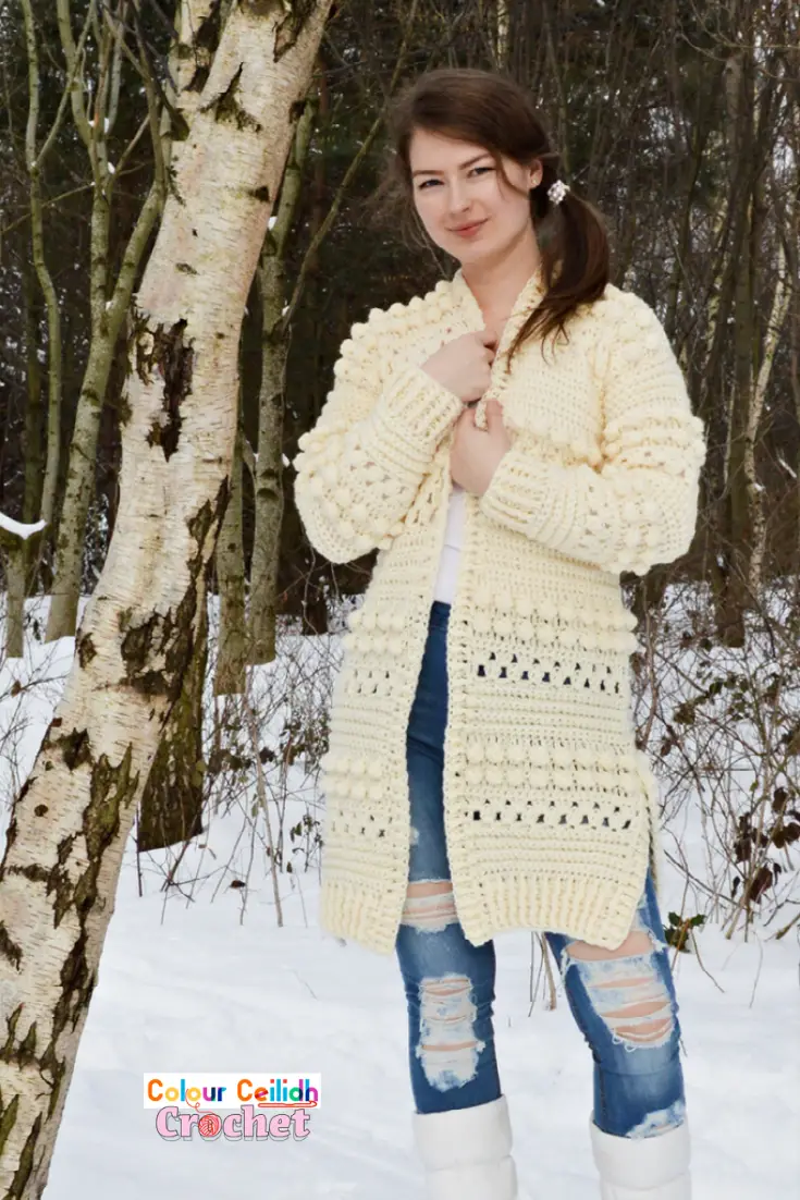 This free pattern for my crochet cardigan Bobbles of Snow is fun & easy to make as it uses the granny stitch and the bobble stitch to create cozy texture for the winter season. This is an open front long cardigan with added side slits for comfort and style. Includes a video tutorial.