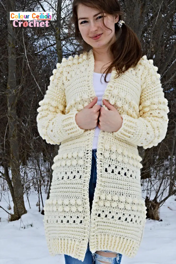 This free pattern for my crochet cardigan Bobbles of Snow is fun & easy to make as it uses the granny stitch and the bobble stitch to create cozy texture for the winter season. This is an open front long cardigan with added side slits for comfort and style. Includes a video tutorial.