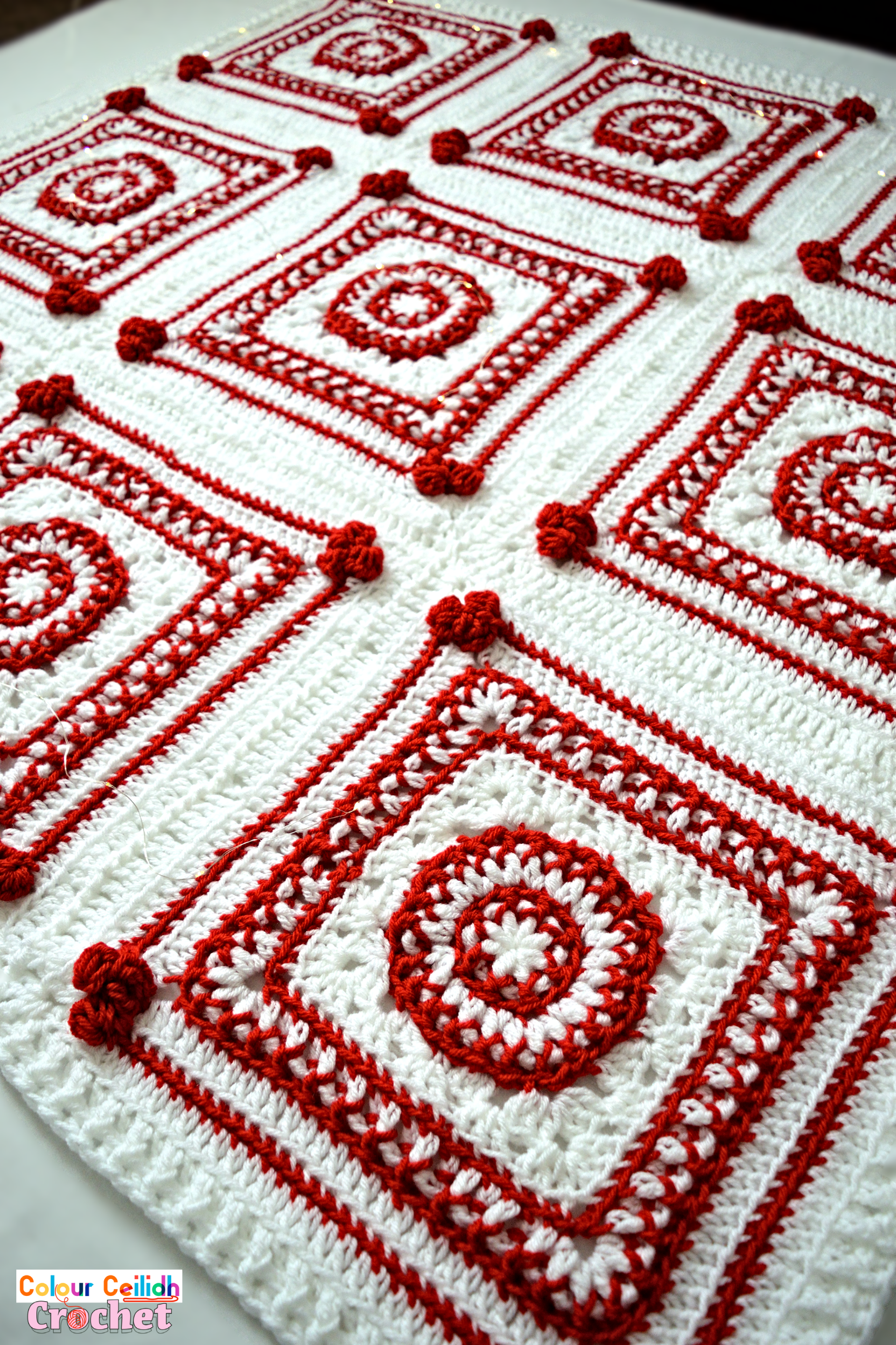 This Christmas crochet blanket pattern is a Scandinavian style afghan with bobble hearts and eight-pointed Nordic stars. Using worsted weight yarn I combine two bold red and white colors for maximum effect to instantly set the Christmas atmosphere. This free pattern includes a YouTube video tutorial. Matching Scandinavian style crochet baubles are available as a separate pattern.