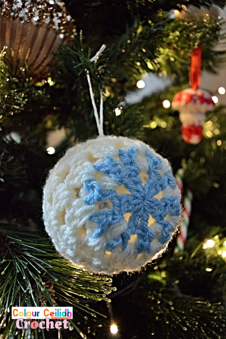 This easy crochet snowflake bauble is made with the granny stitch and is suitable for beginners. The lace looks great on a see-through bauble, especially if you hang it in front of some twinkling Christmas lights. It makes a great addition to your handmade crochet Christmas ornaments. Oh and there is no starch involved!