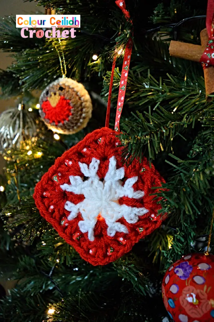 This easy crochet snowflake ornament is quick to make, is suitable for beginners and requires no starch! Now that's my kind of snowflake. Simply make it & hang it! This crochet snowflake ornament is made with two easy snowflake granny squares laced together with a ribbon and is part of my Christmas crochet patterns collection. A YouTube video tutorial is also available to aid you with making the square as it's a part of the crochet snowflake hat & cowl pattern.